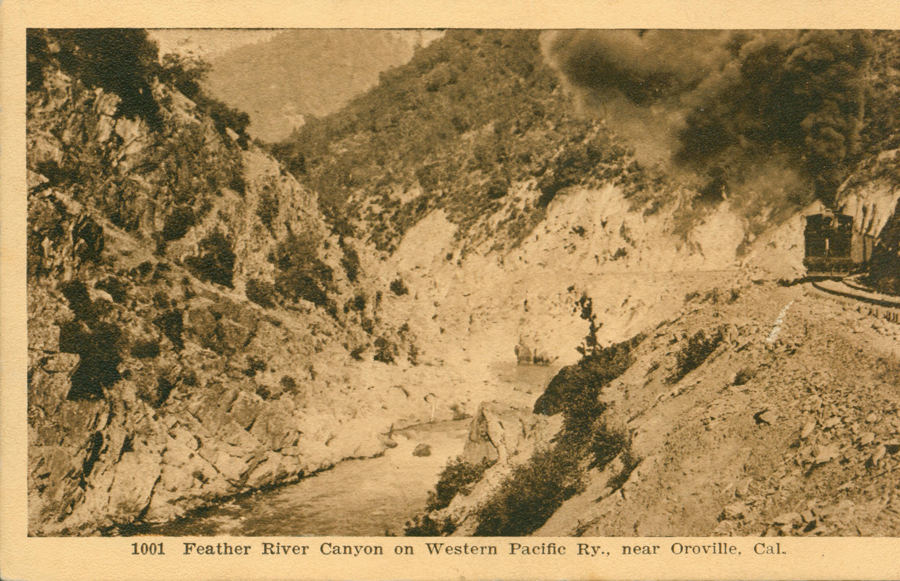 Shows a train steaming along the edge of the Feather River Canyon