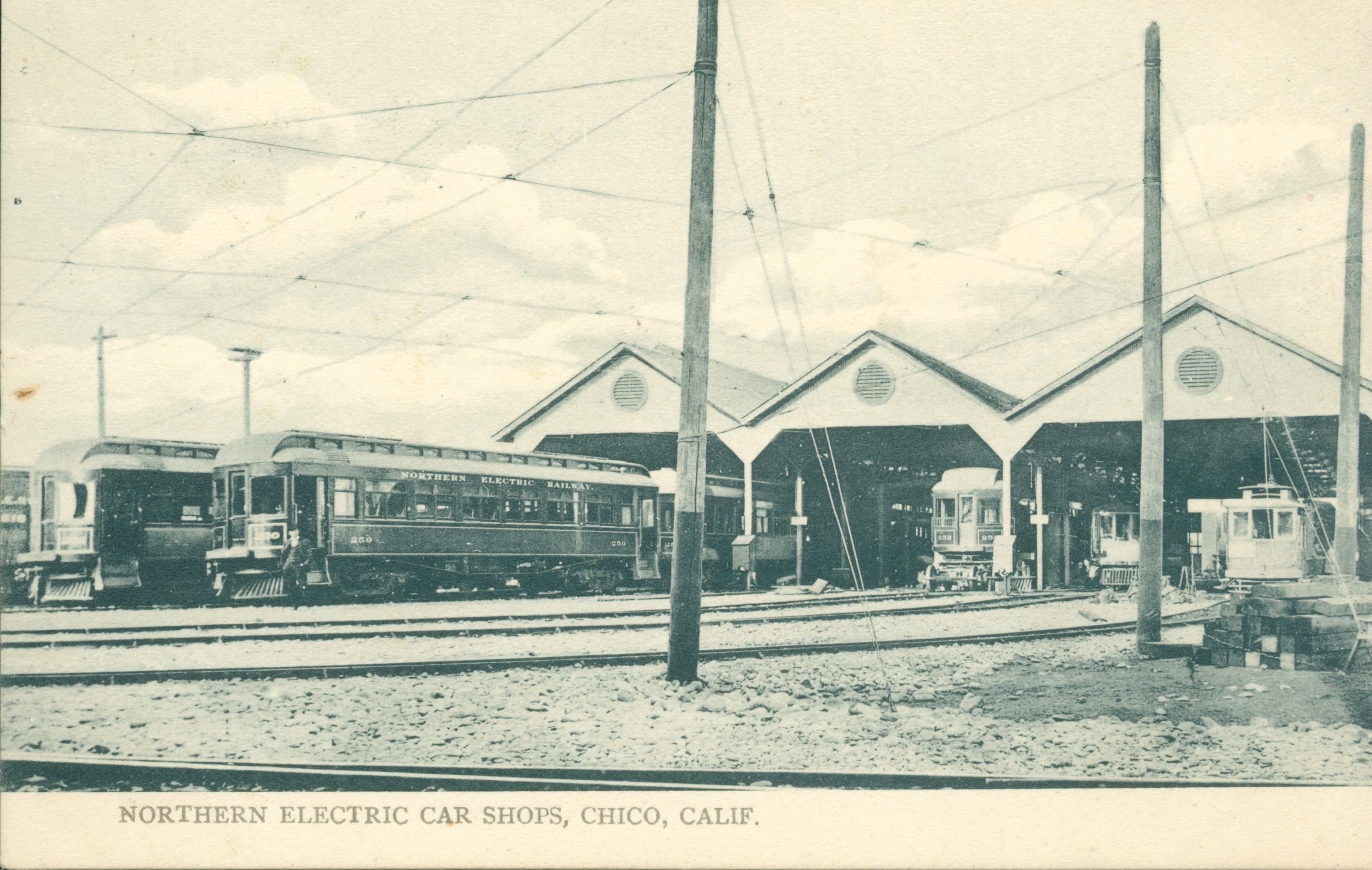 Shows several railcars and sheds