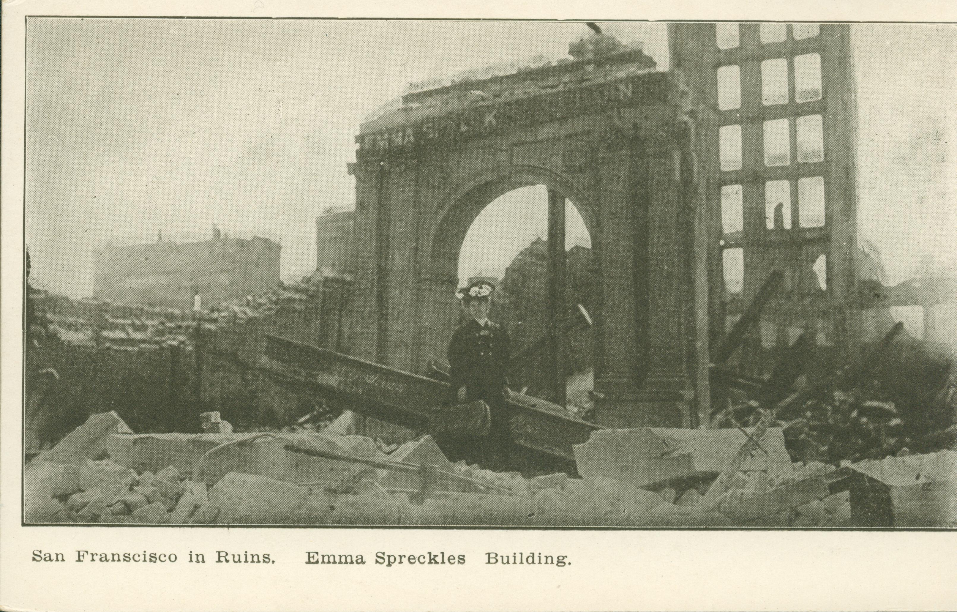Shows a woman in front of what is left of a building.