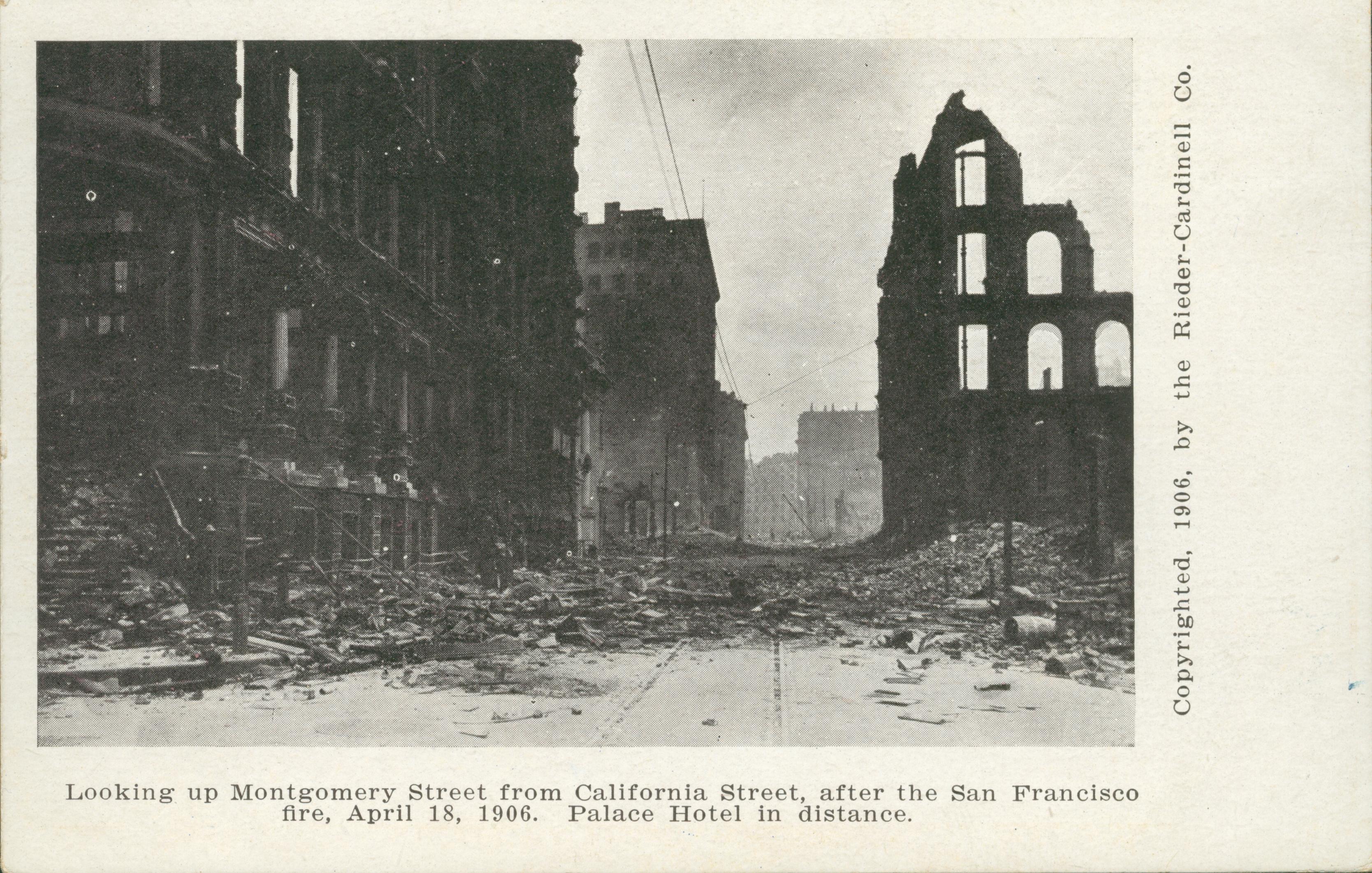 Shows destroyed building on both sides of a street with the Palace Hotel in the background.