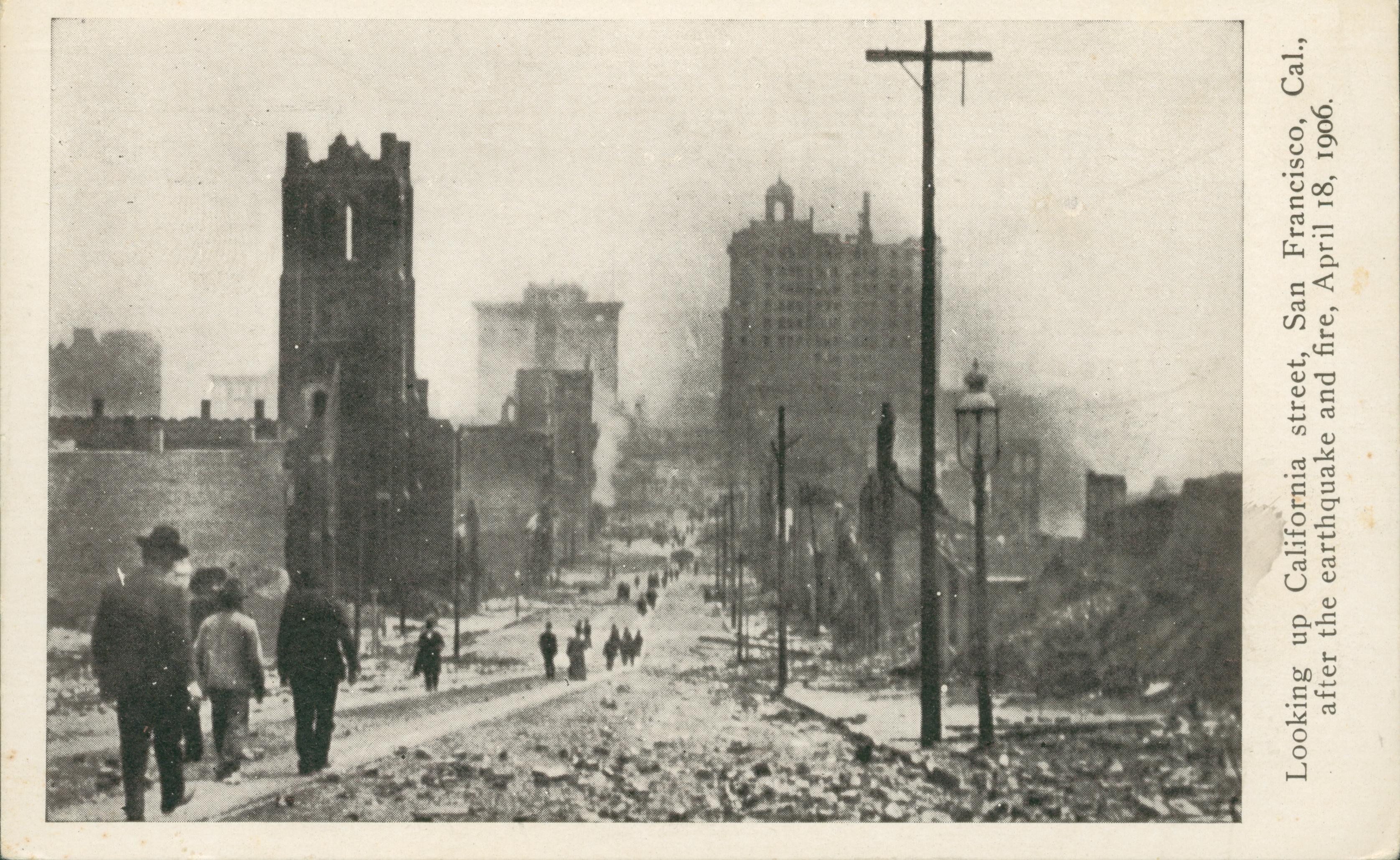 Shows people walking down the street with rubble and destroyed buildings on either side.