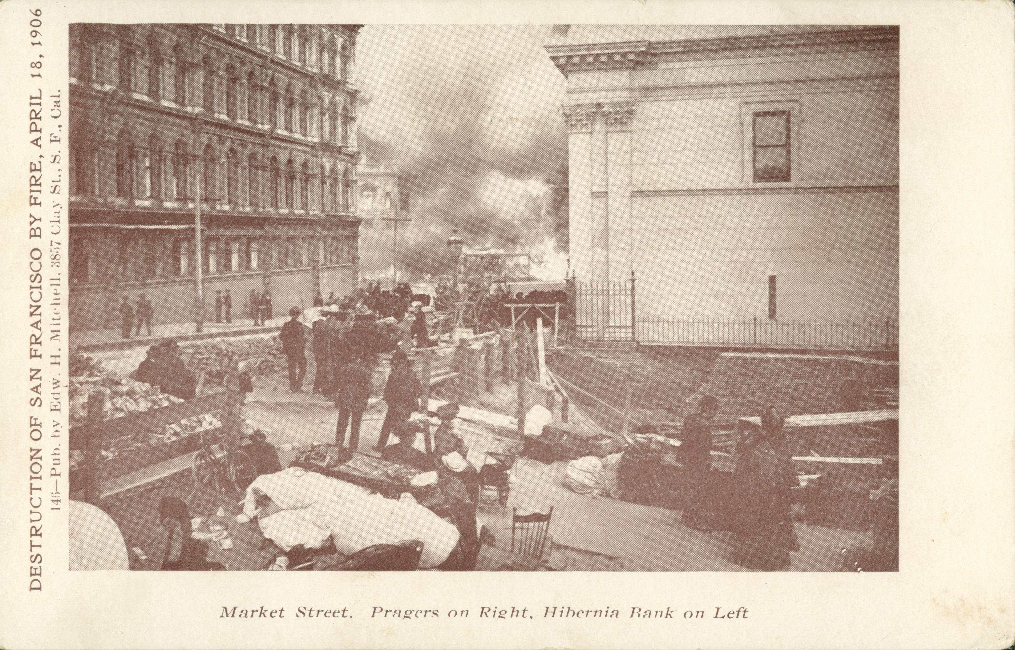 Shows people watching a fire on Market Street, San Francisco, California.