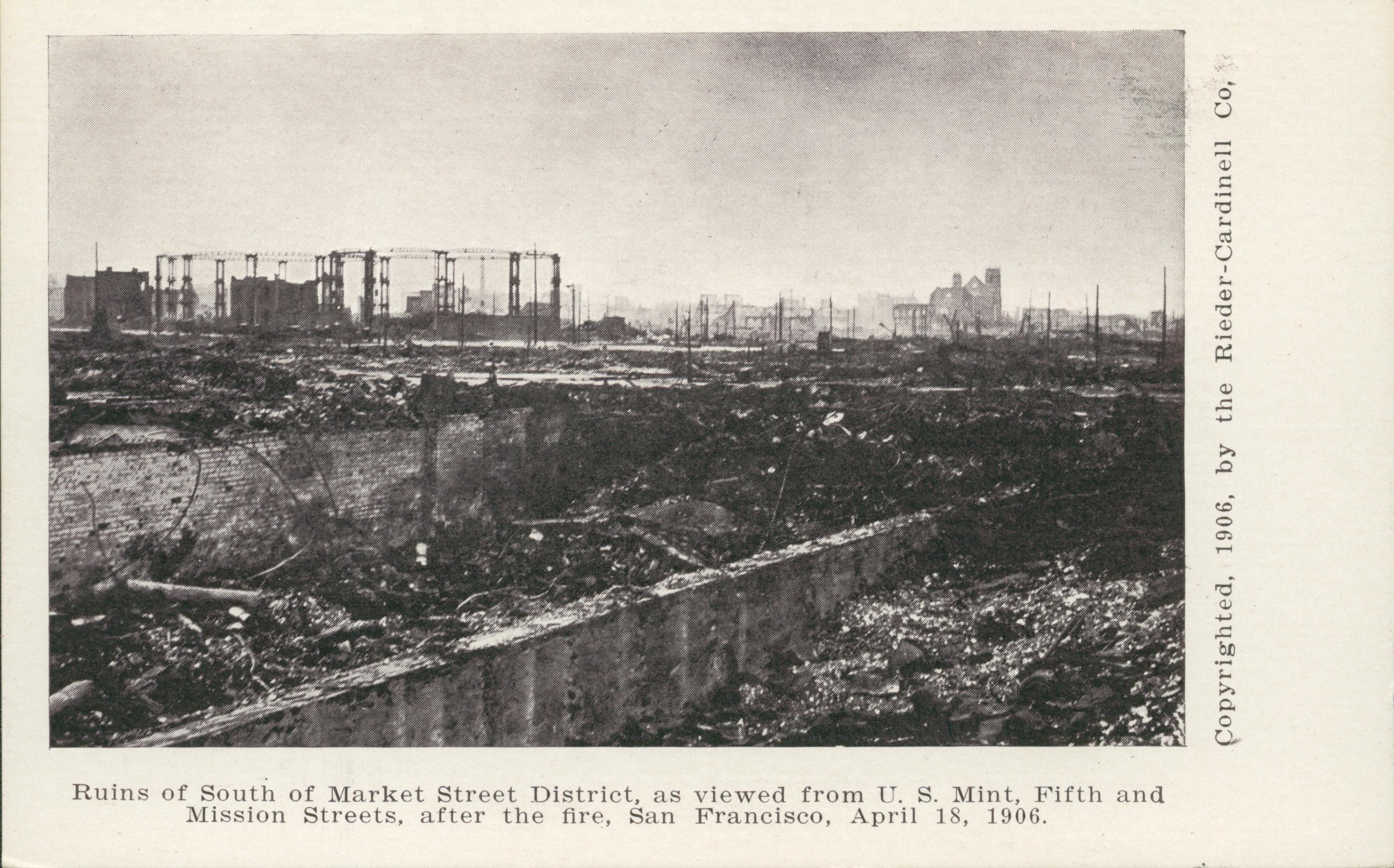 Shows a desolate landscape covered in rubble with a few ruined buildings.