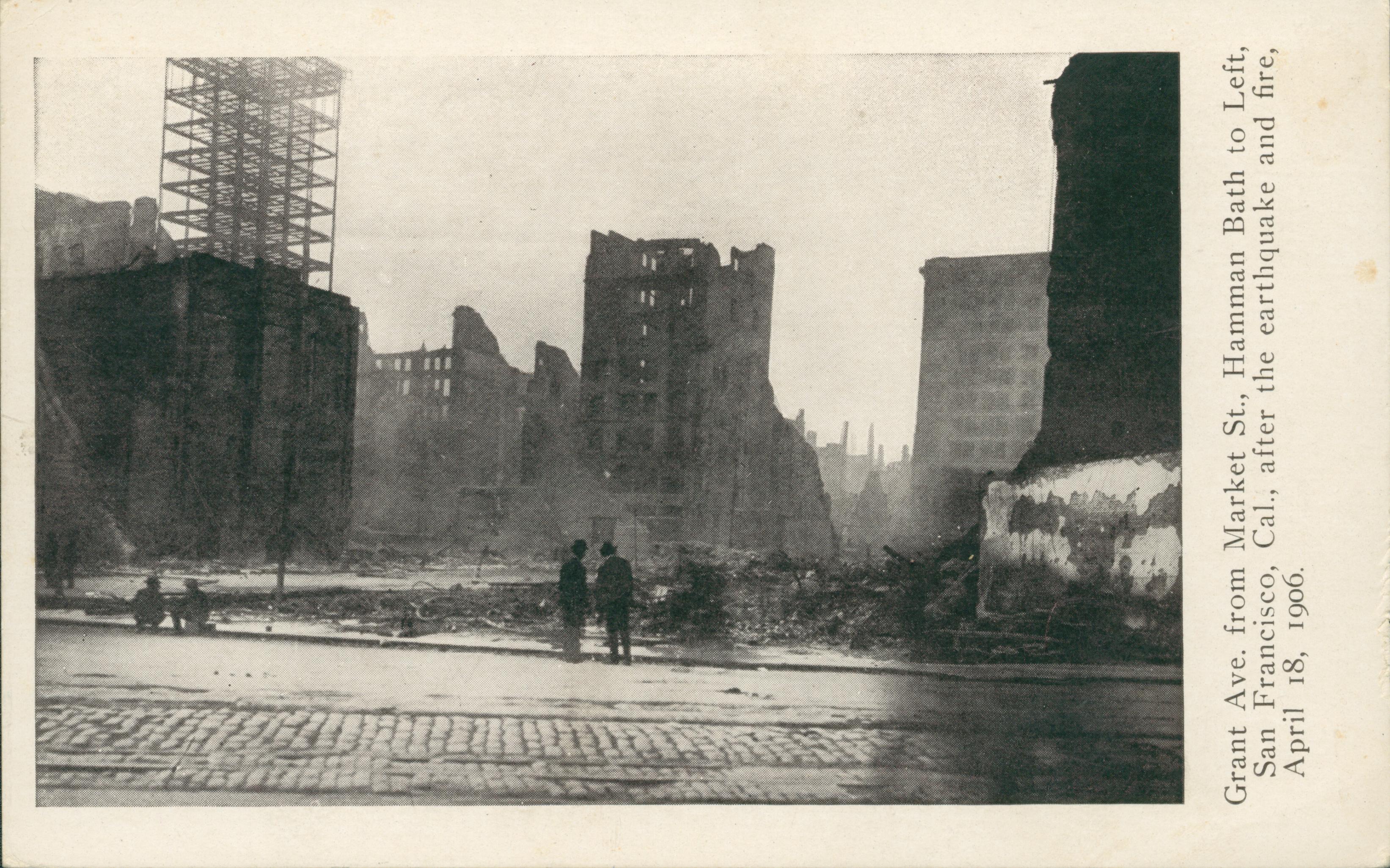 Shows four men looking at several destroyed buildings.