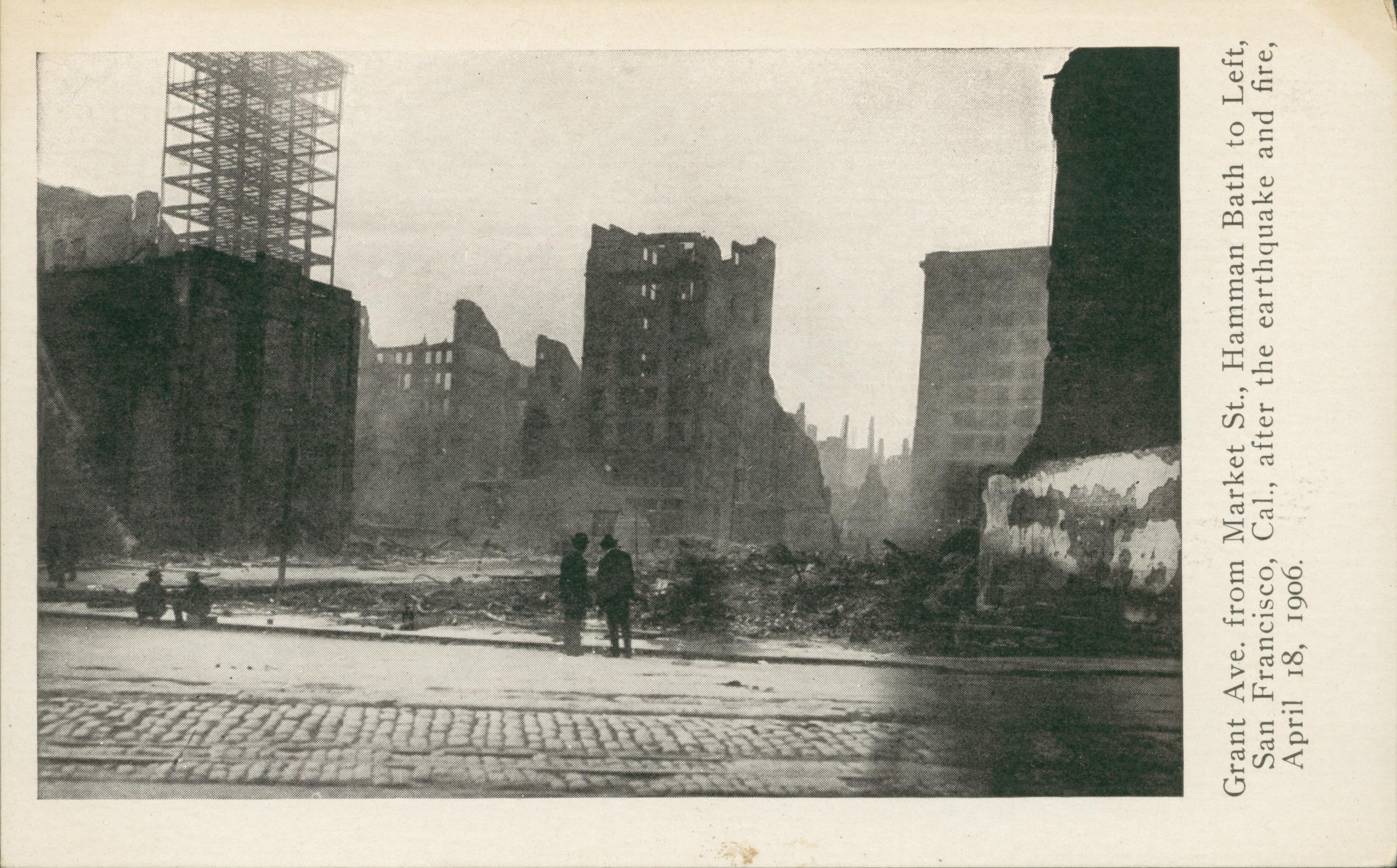 Shows four men looking at several destroyed buildings.