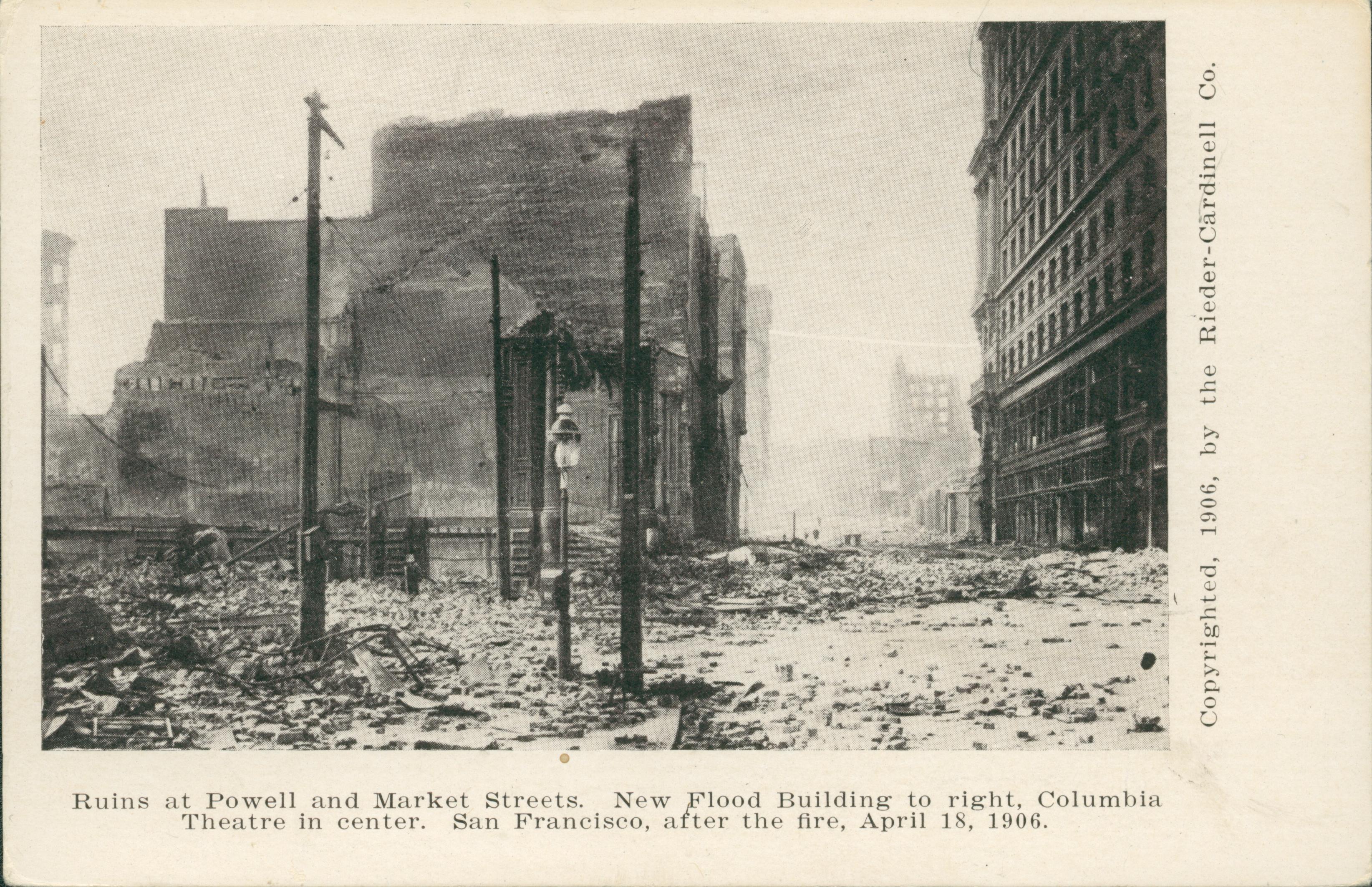 Shows the street covered in rubble with a collapsed building on the left.