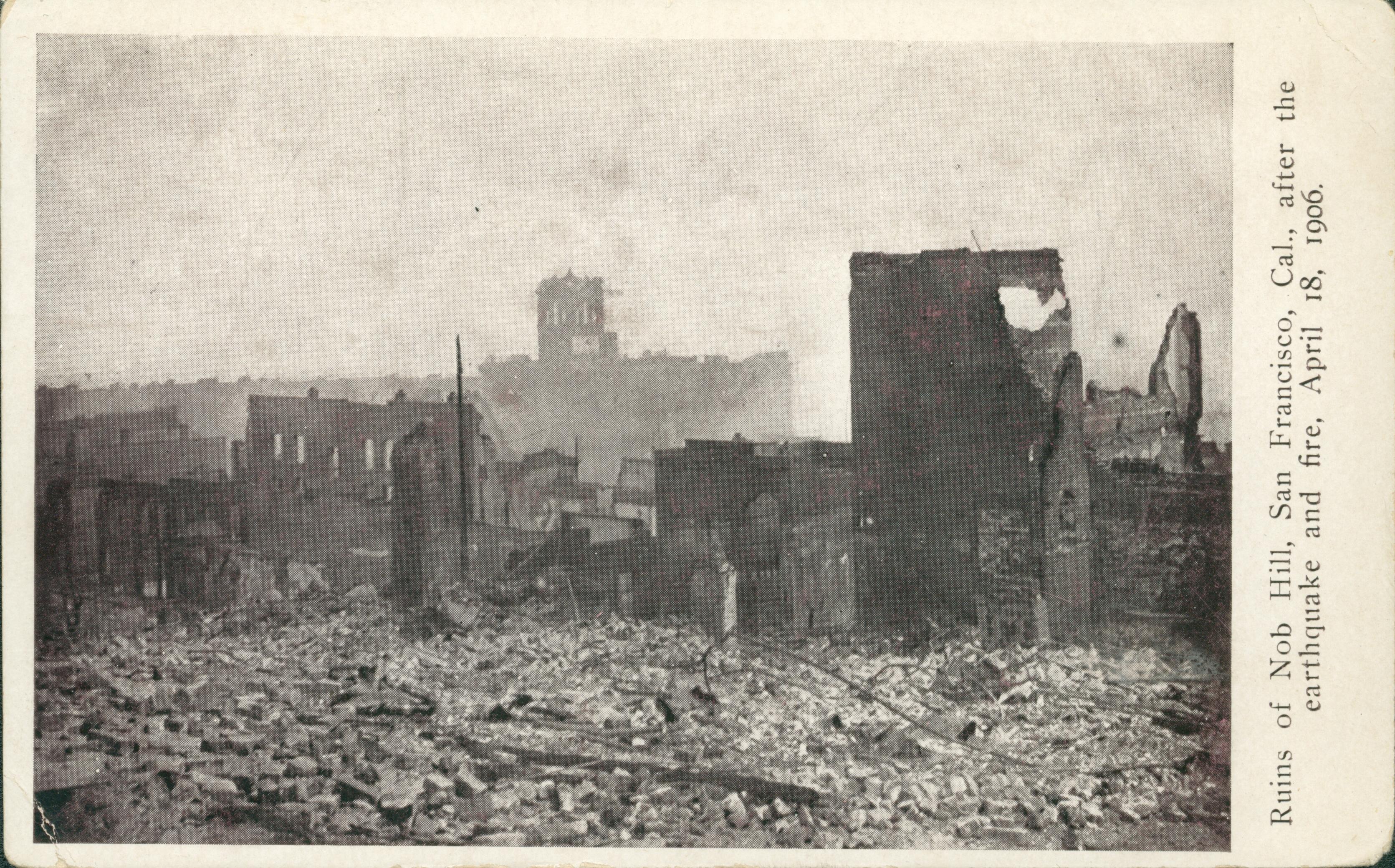 Shows the ground covered in rubble with collapsing building all around.