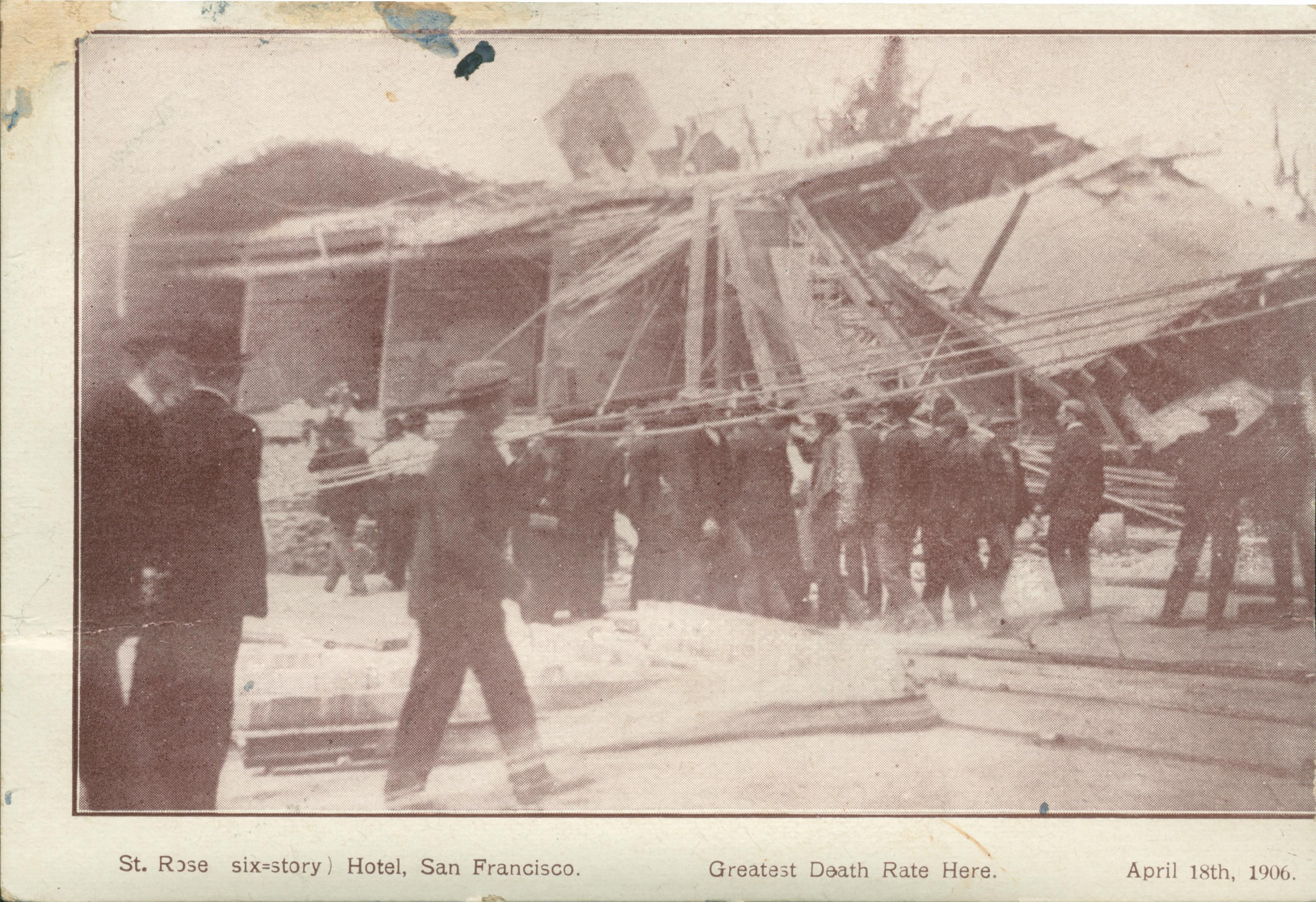 Shows a group in front of a collapsed building.
