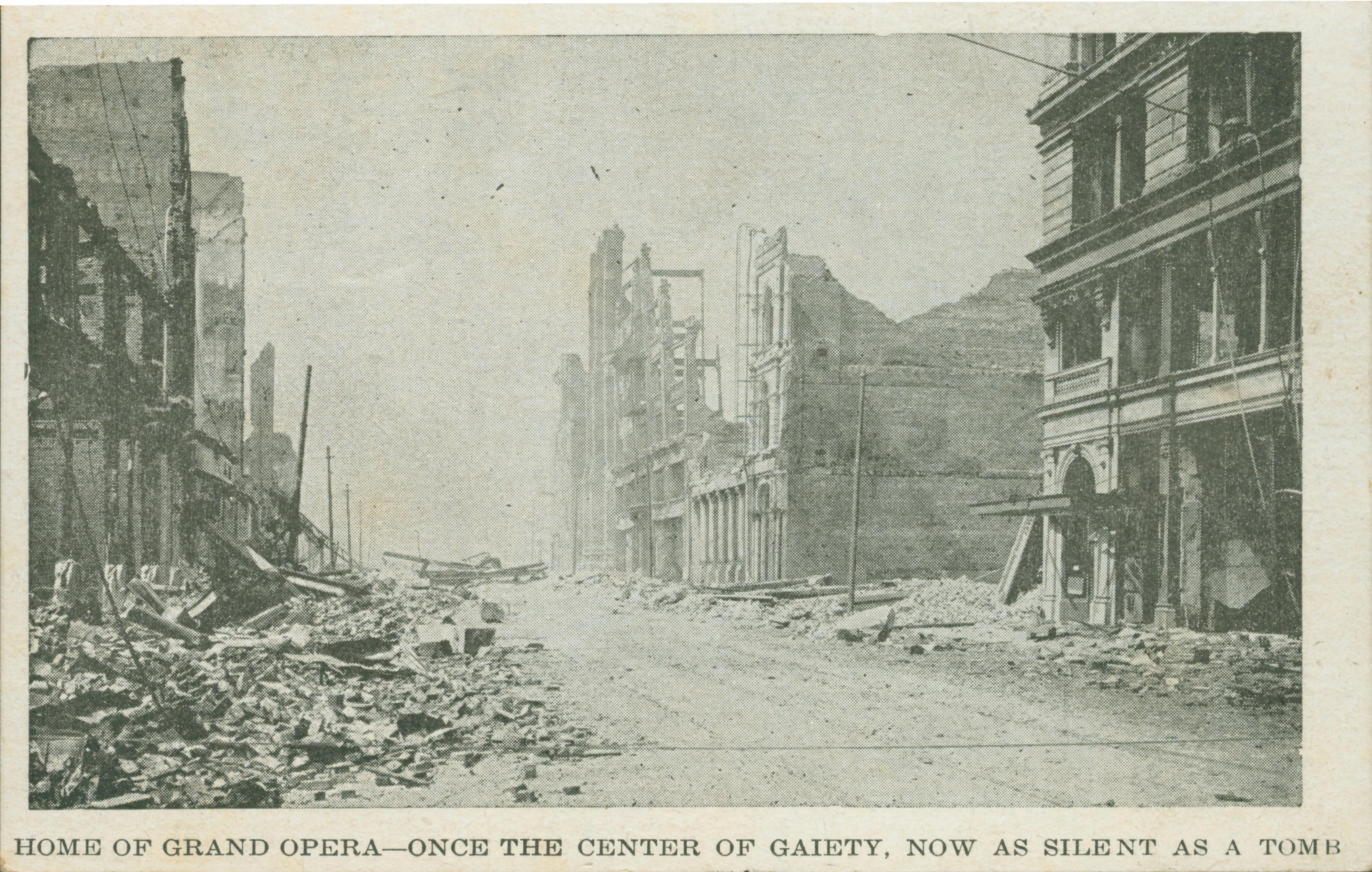Shows an empty street covered in rubble with collapsed building on either side.