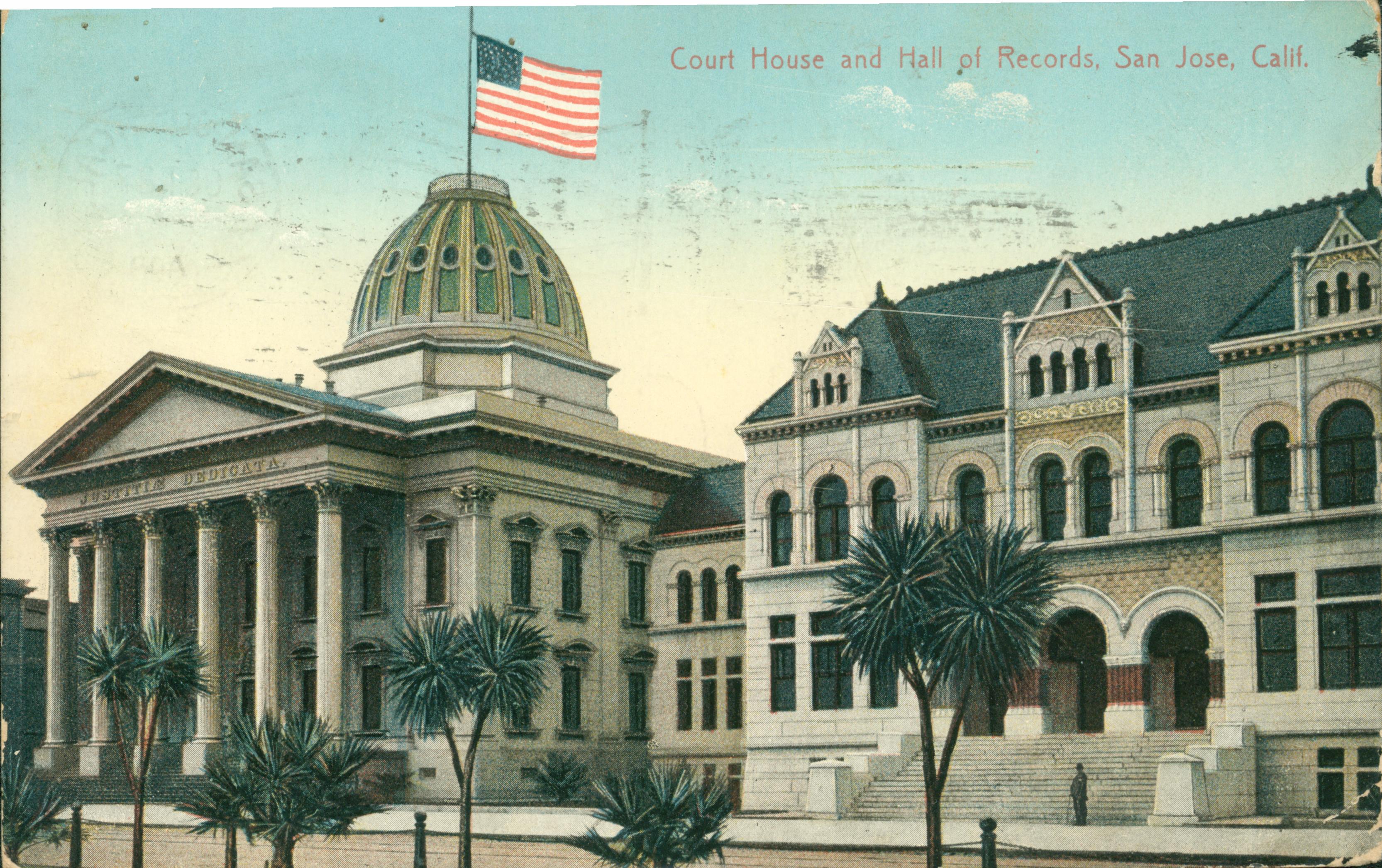 Exterior view of Court House and Hall of Records, palm trees and American flag