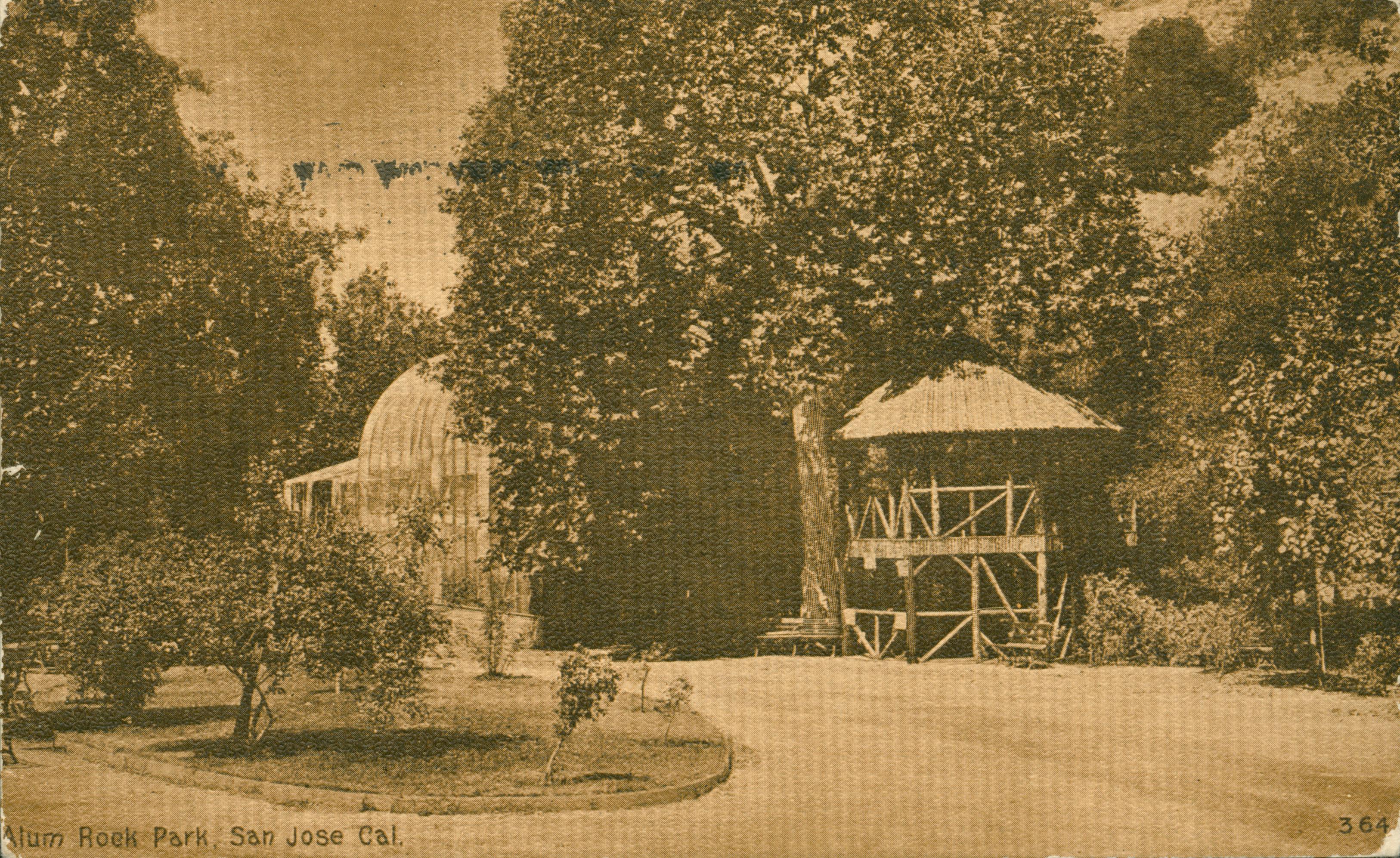 View of Alum Rock Park with trees, gazebo, greenhouse and road