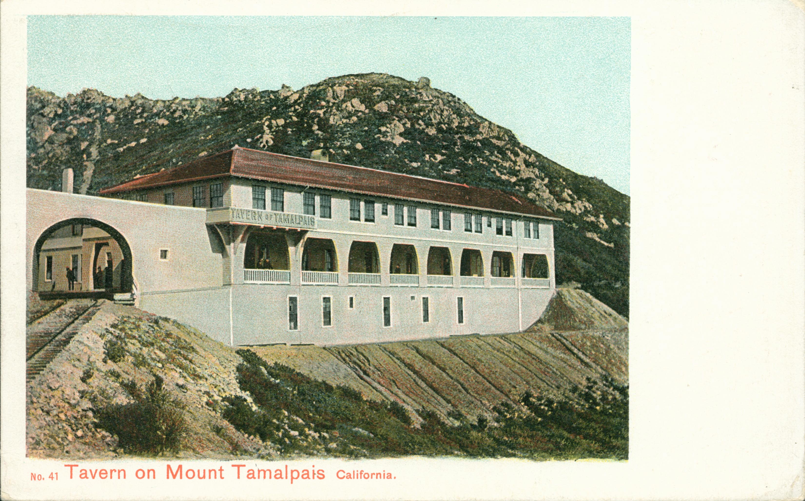 View of Mt. Tamalpais, trees, hills and buildings in background, train tracks in foreground