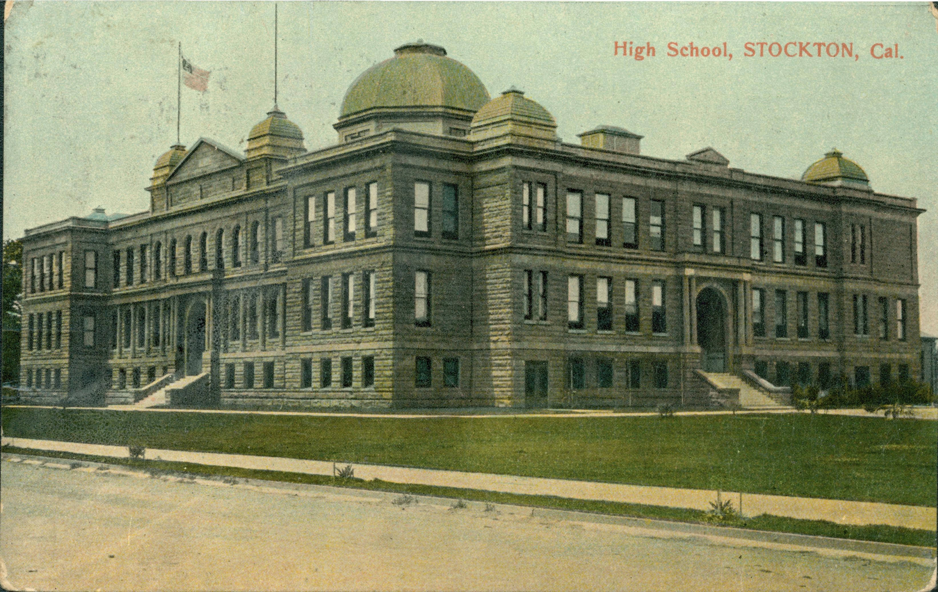Exterior view of the high school, multi-story building, large grass lawn