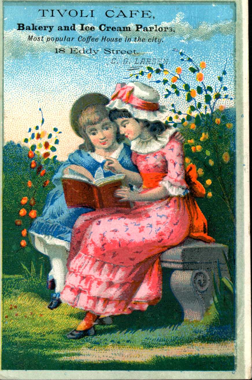 Shows two girls seated on a bench reading