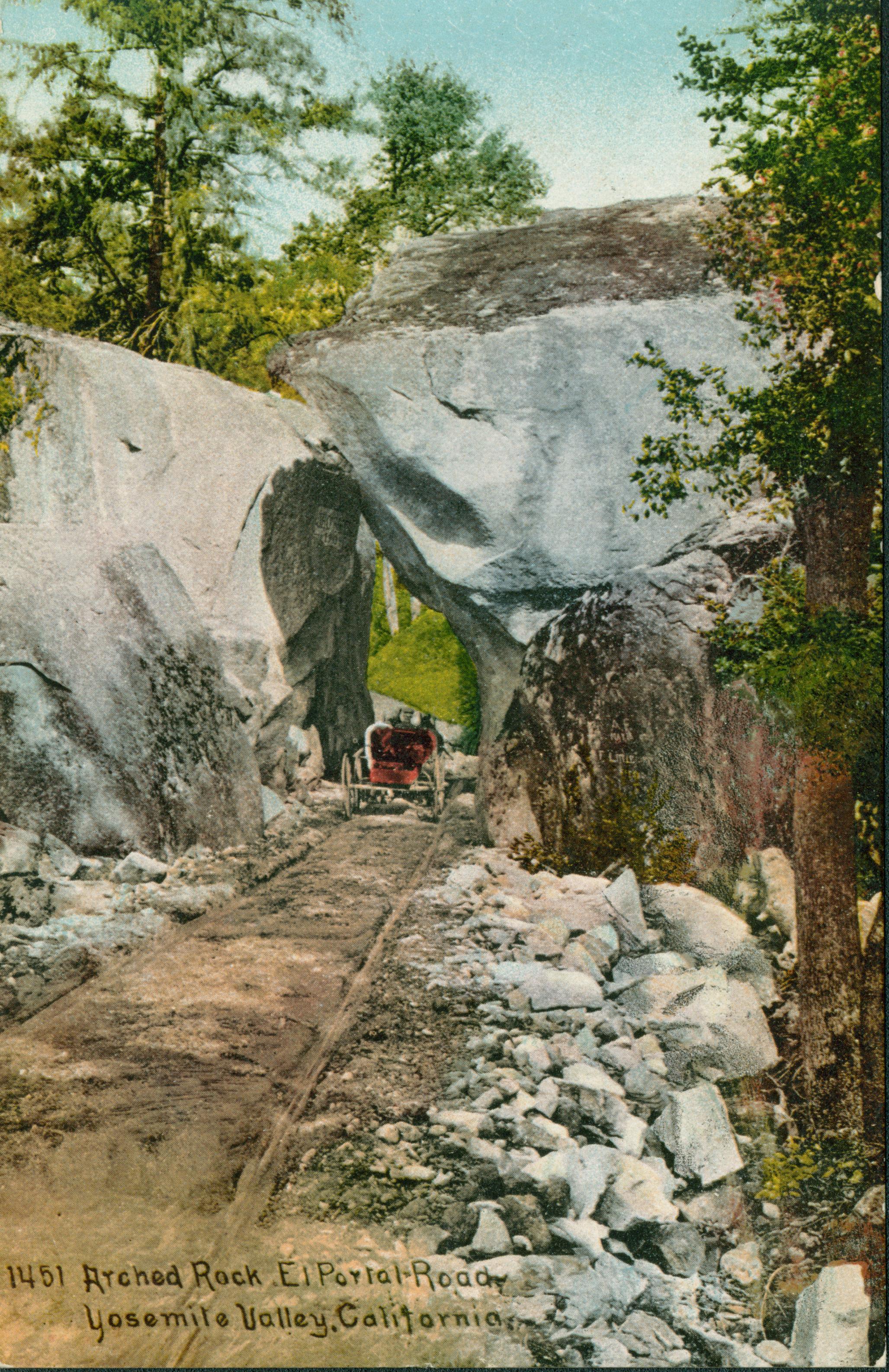 Shows a carriage driving through Arch Rock.