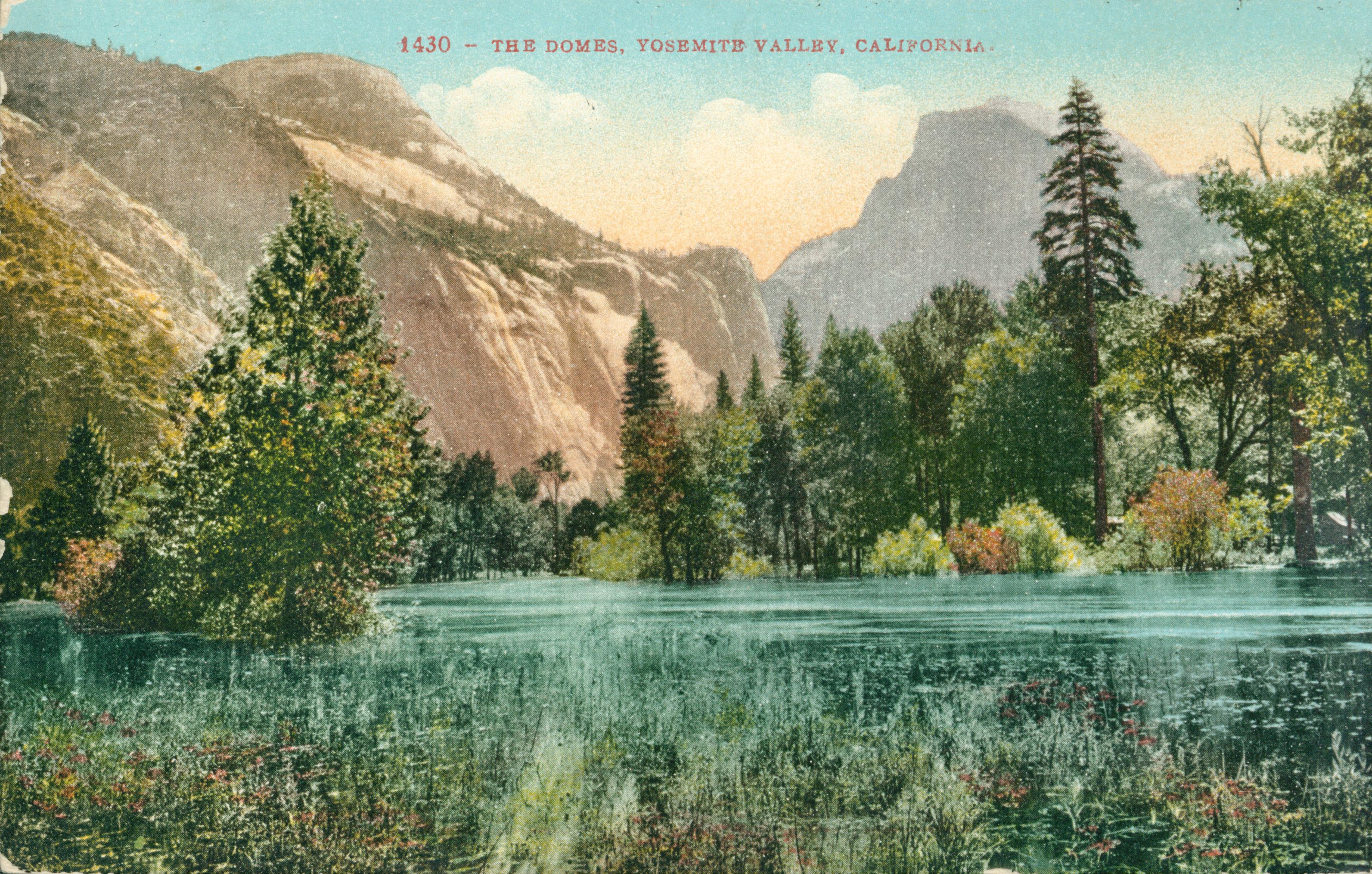 Shows a tree-lined lake or pond with the various rock formations including Half Dome in the background