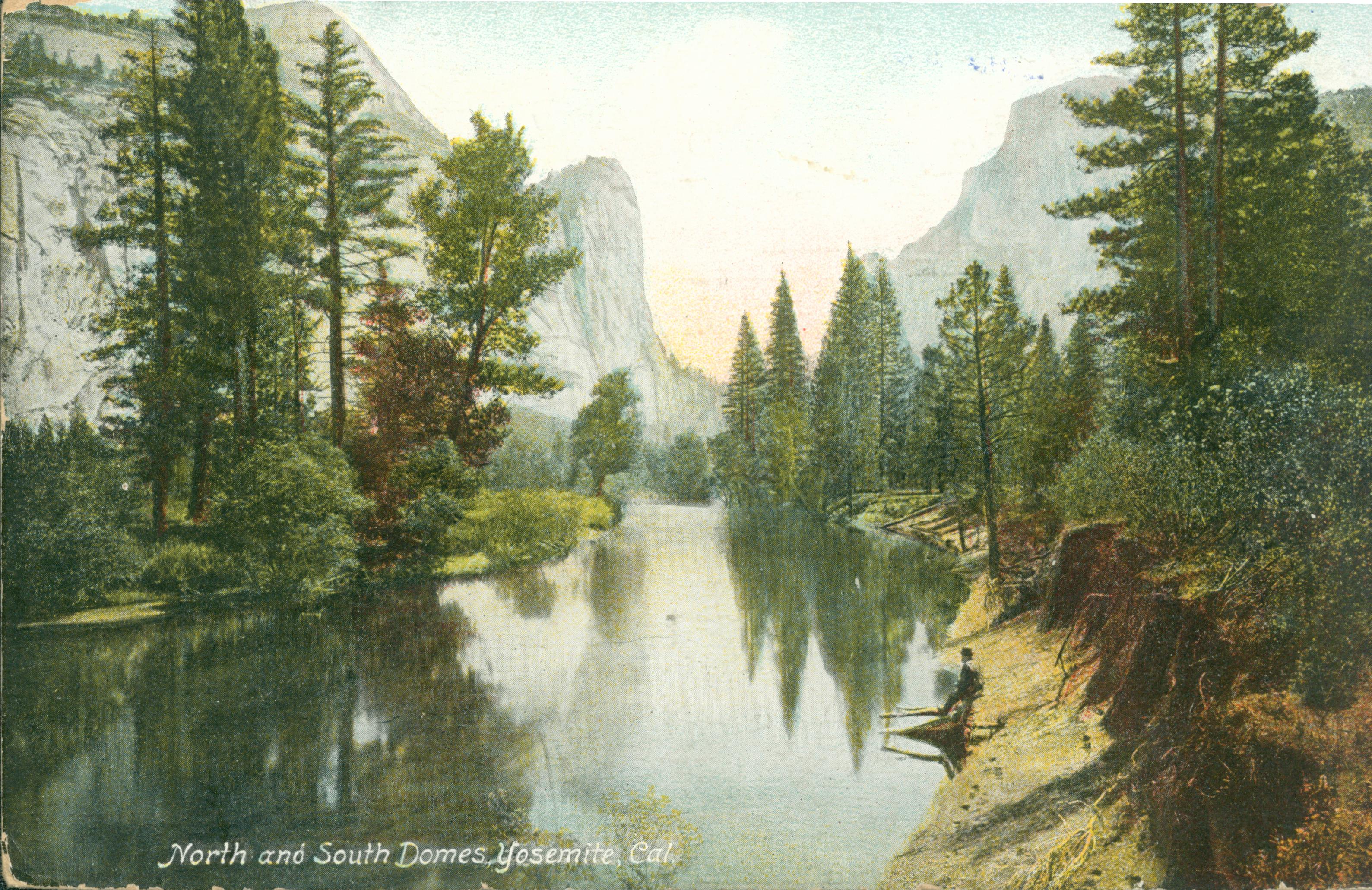 Shows a tree-lined river with a person sitting on the shore. In North and South Dome are in the background.