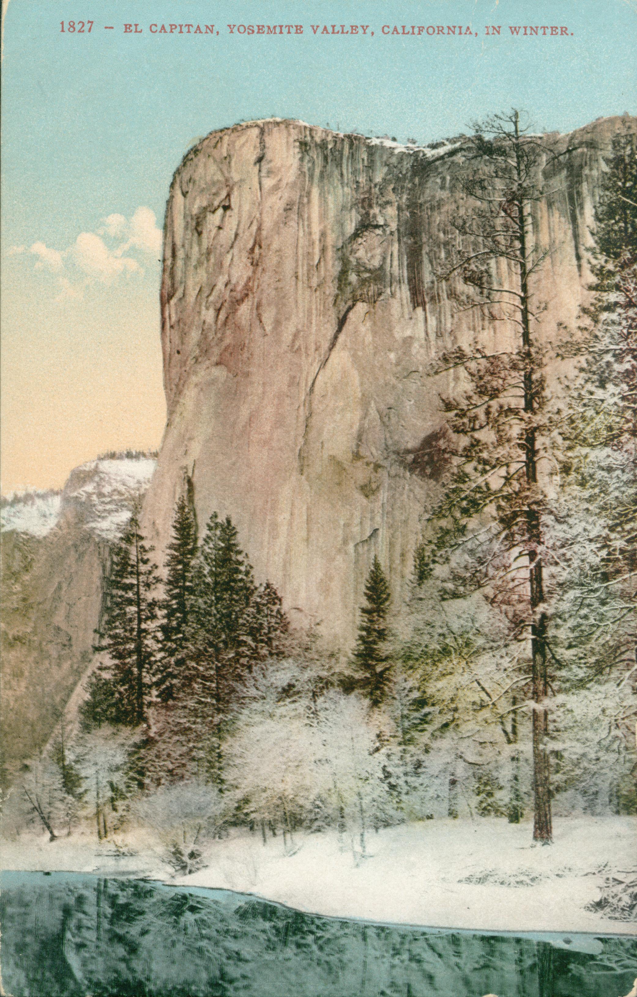 Shows El Capitan looming above a tree-lined river, the ground and trees are covered in snow