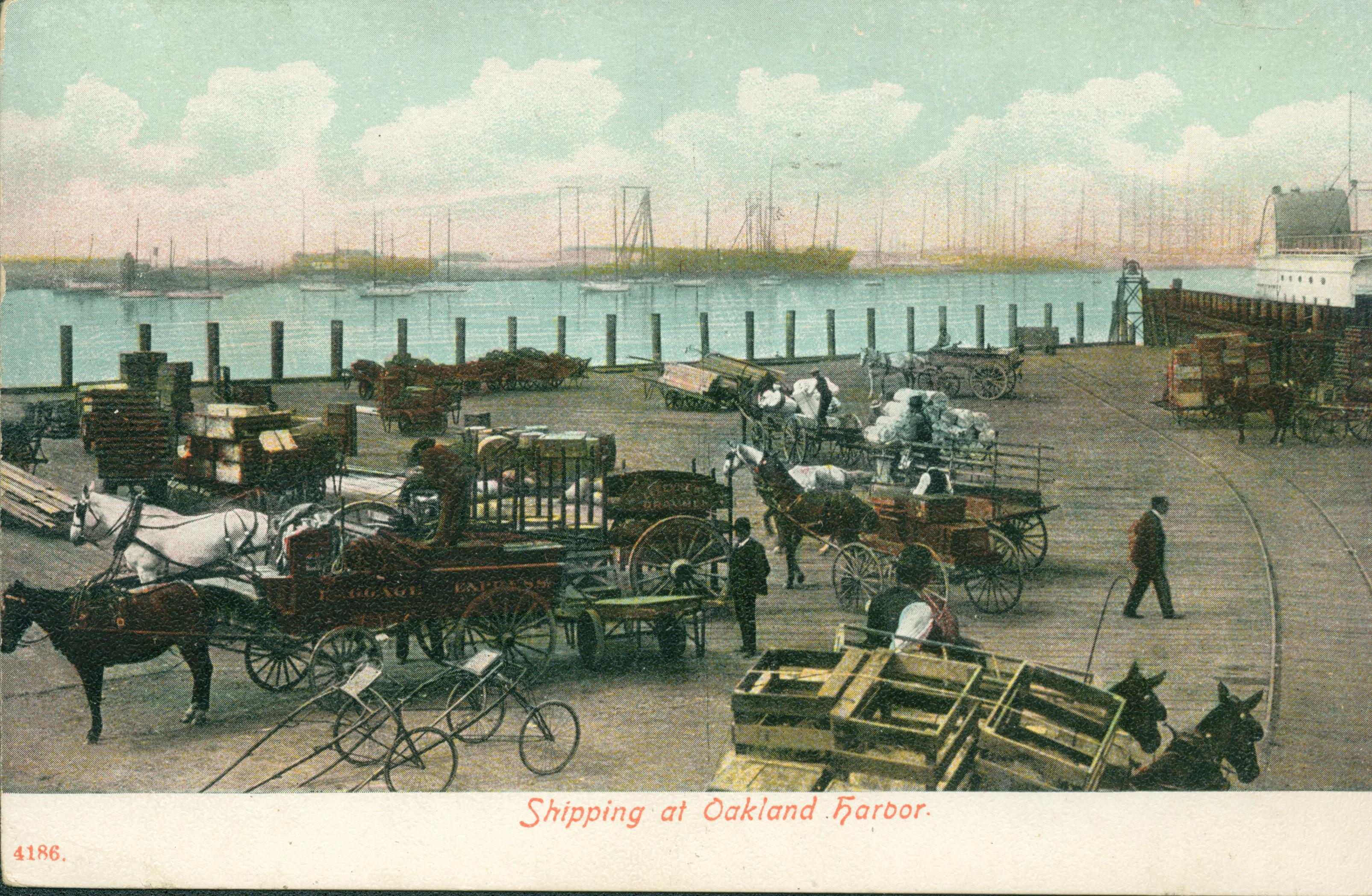 Shows several carts and wagons waiting at the dock with ships in the background
