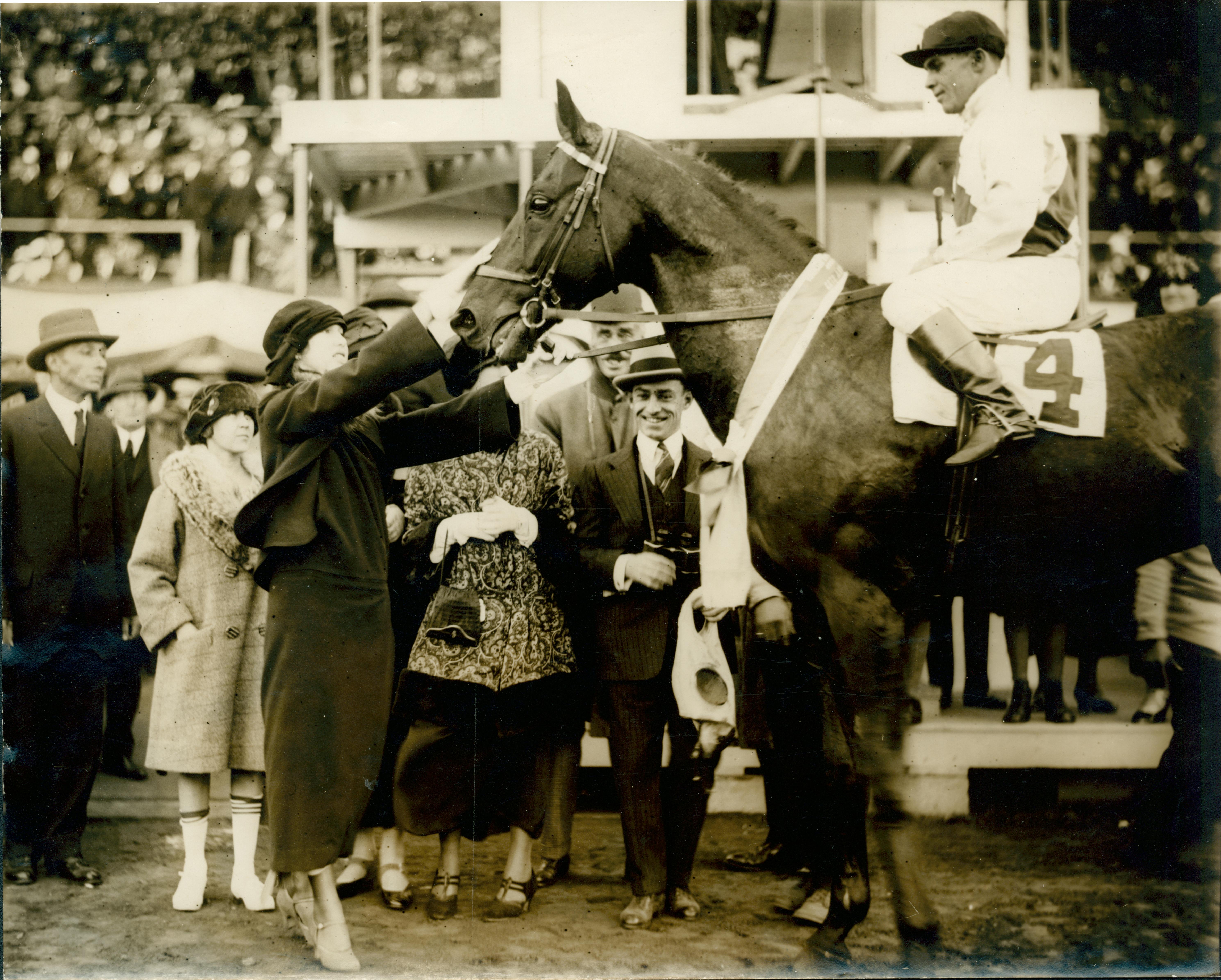 Scanned image is of Miss Spreckles stroking horse