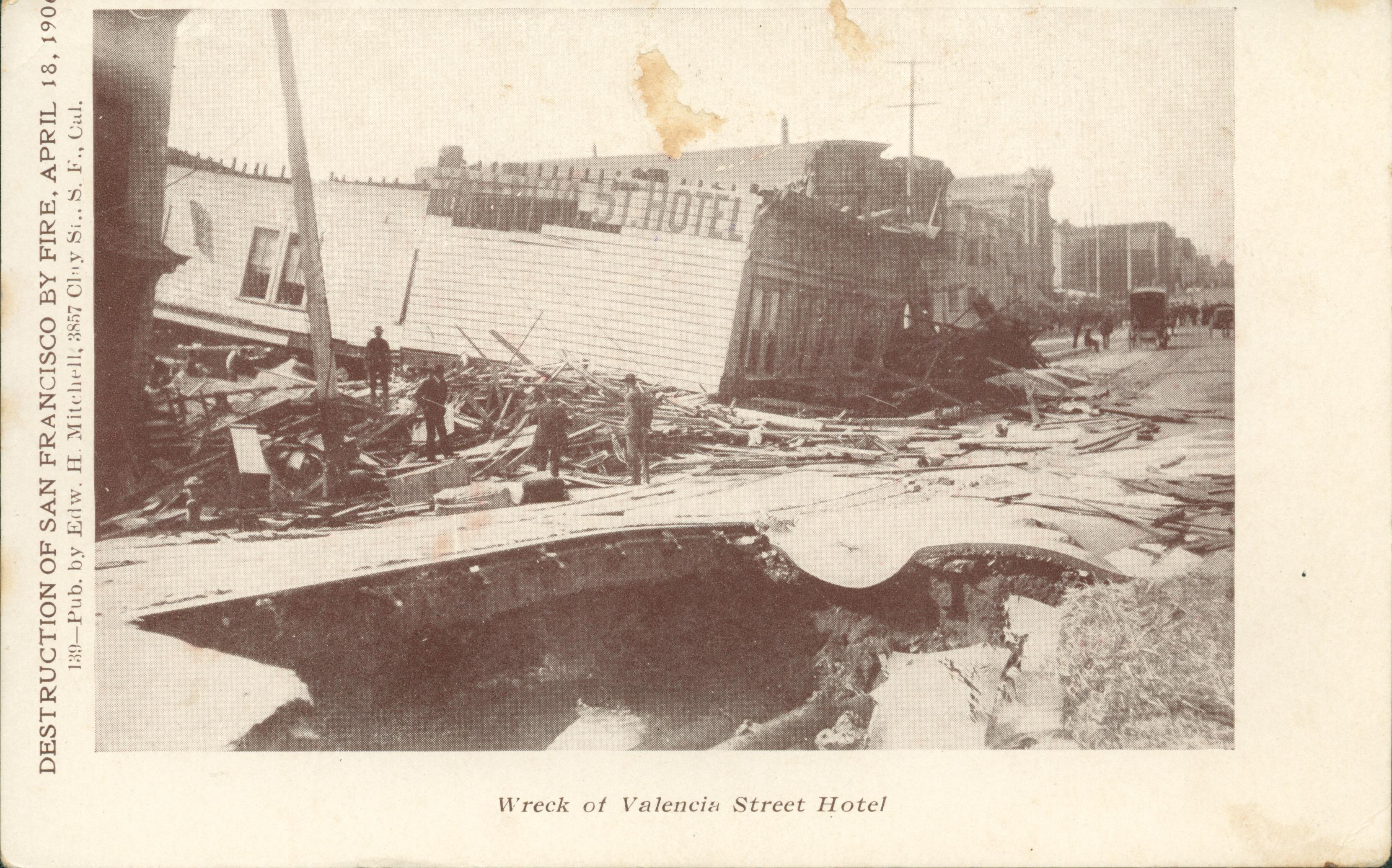 Shows the Valencia Street hotel, collapsing onto the street, surrounded by other buildings