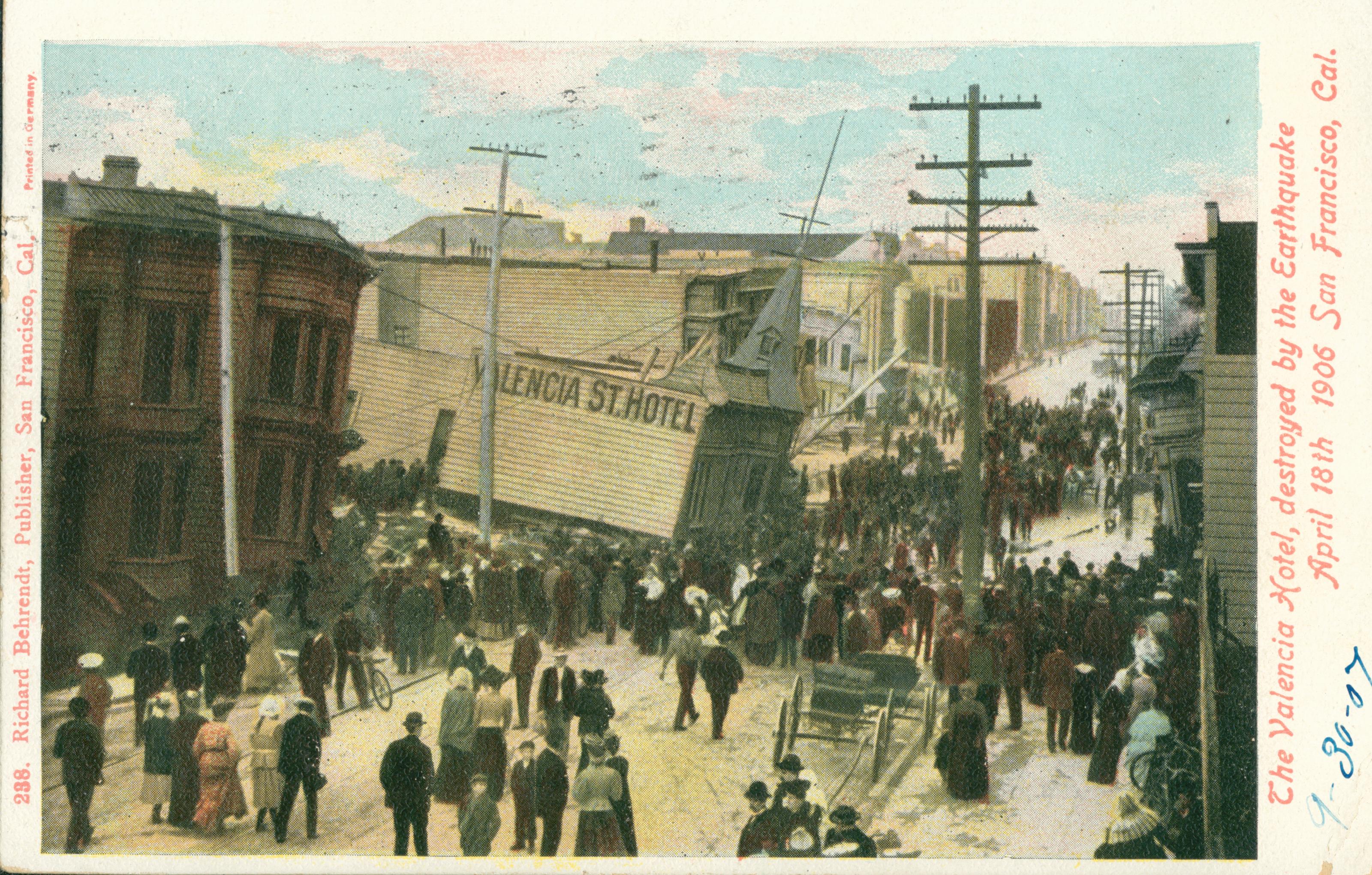 Shows the Valencia Street hotel, collapsing onto the street, surrounded by other buildings and a crowd of spectators