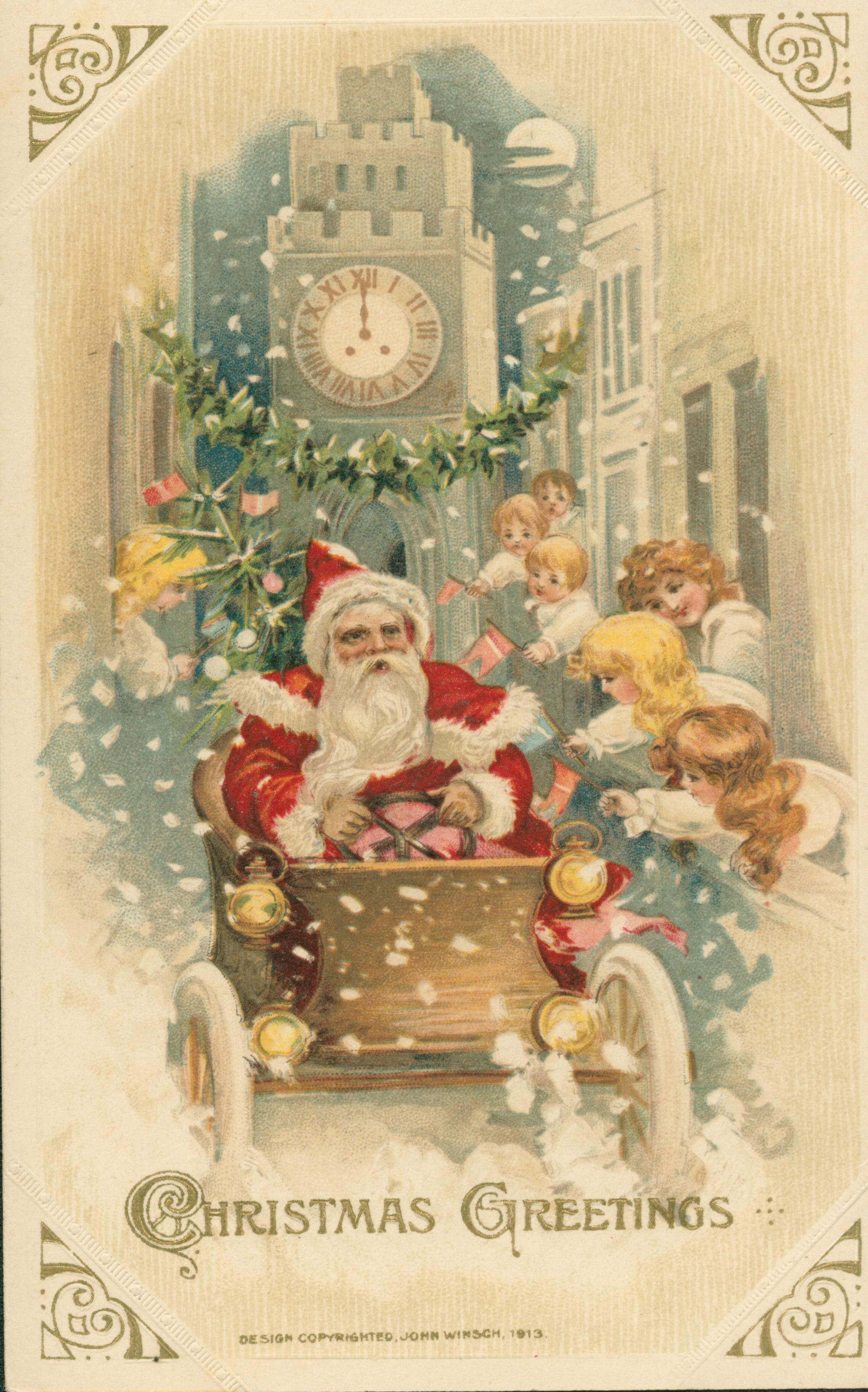 Shows Santa Claus in driving a car through a narrow street, with children leaning out the windows